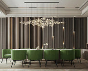 Dining room design with white marble top and green velvet chairs.