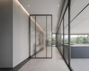 Minimalist Transition Corridor with Textured Glass Feature Wall and Full-Height Fenestration