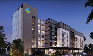 Curved-Corner High-Rise Hospital with Mixed Material Façade and Night Illumination