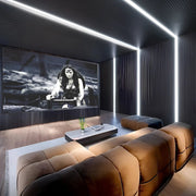 Futuristic Black & Walnut Home Theatre with Plush Loungers and Linear Glow
