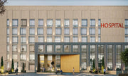 Minimalist Grid-Façade Hospital with Stone Texture Finish
