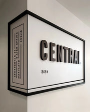 Architectural Corner Signage with Bold Typography and Framed Dimensional Impact