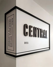 Architectural Corner Signage with Bold Typography and Framed Dimensional Impact