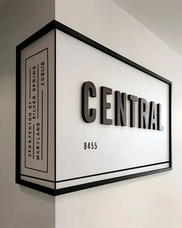 Architectural Corner Signage with Bold Typography and Framed Dimensional Impact