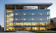 Sleek Glass-Façade Urban Hospital with Exposed Stairwell and Structural Canopy