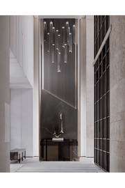 Sleek Foyer Design with Cascading Chandelier and Black Marble Wall