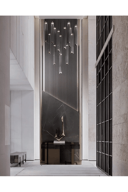 Sleek Foyer Design with Cascading Chandelier and Black Marble Wall