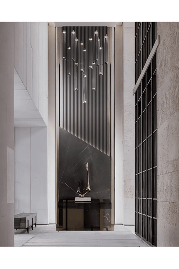 Sleek Foyer Design with Cascading Chandelier and Black Marble Wall